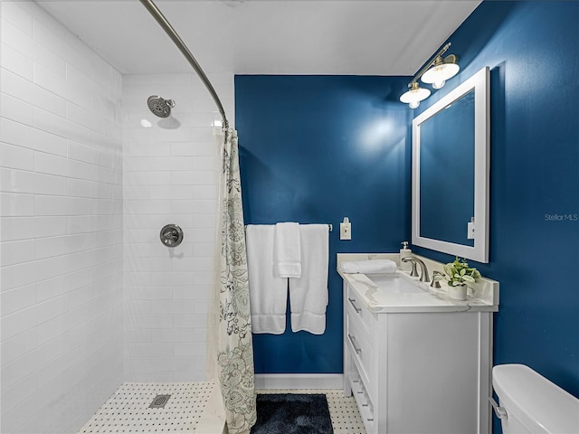 bathroom featuring toilet, walk in shower, and vanity