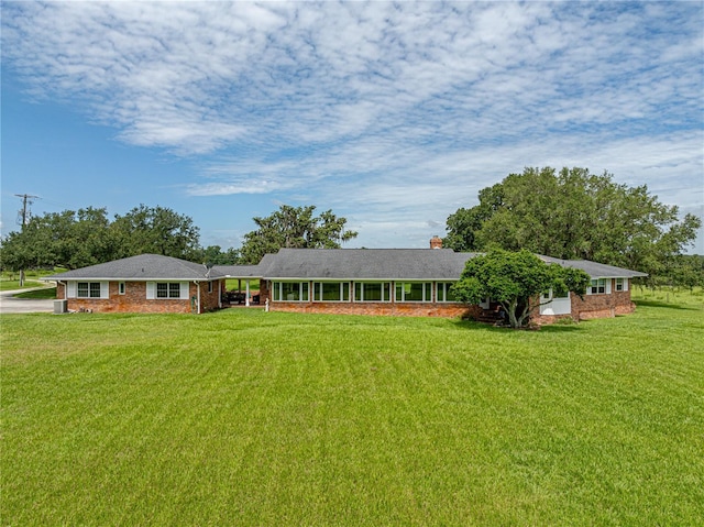 ranch-style home featuring a front yard