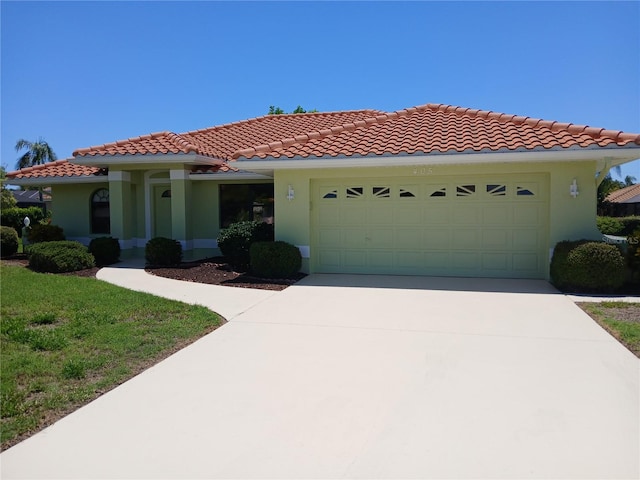 mediterranean / spanish house with a garage