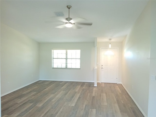 empty room featuring hardwood / wood-style flooring and ceiling fan