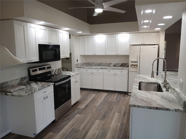 kitchen featuring white cabinetry, sink, light stone countertops, wood-type flooring, and stainless steel electric stove