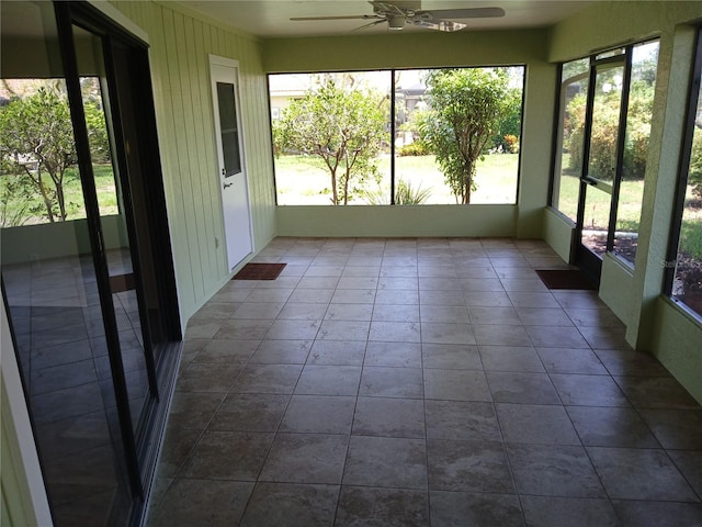 unfurnished sunroom with ceiling fan