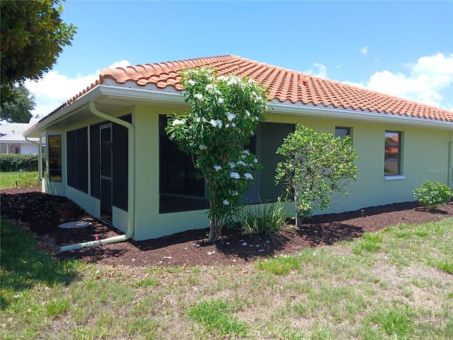 view of home's exterior with a sunroom