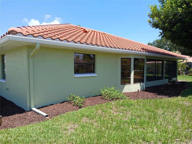 back of house featuring a sunroom