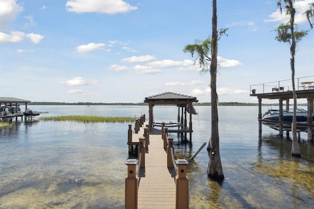 dock area with a water view and boat lift