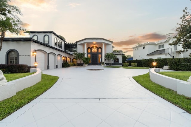 mediterranean / spanish-style house featuring concrete driveway and stucco siding