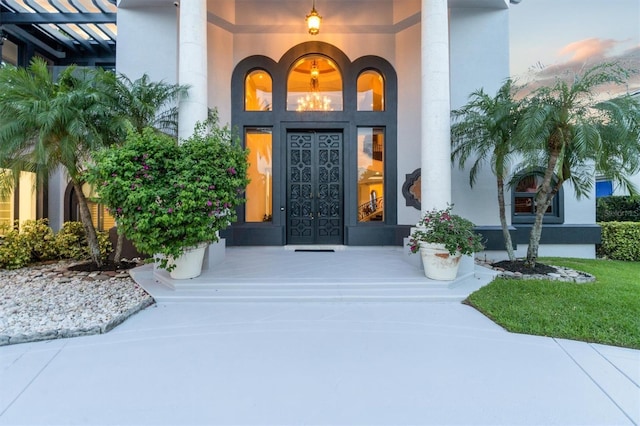 doorway to property featuring stucco siding