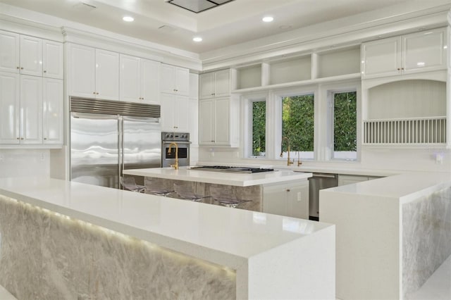 kitchen featuring stainless steel appliances, recessed lighting, white cabinets, and light countertops