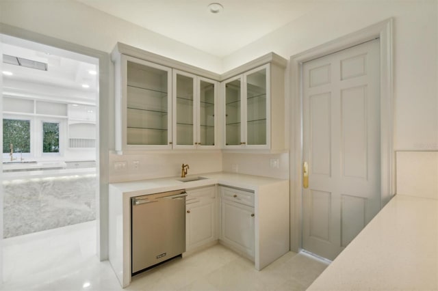 bar with a sink, stainless steel dishwasher, and recessed lighting