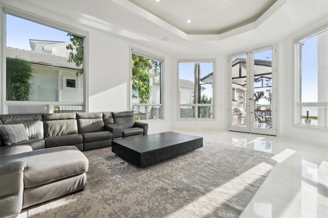 living room featuring a tray ceiling, french doors, and recessed lighting