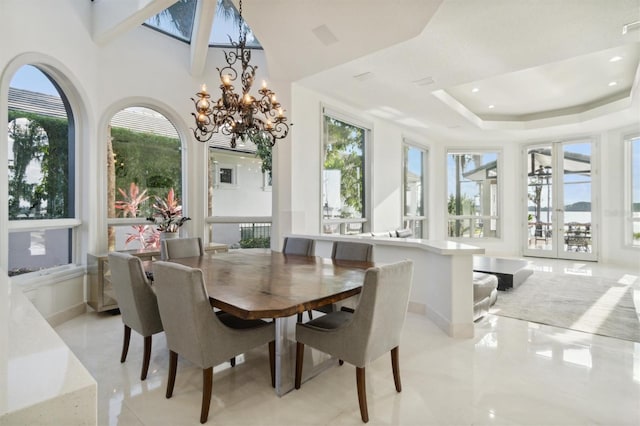 dining area with recessed lighting, baseboards, french doors, a raised ceiling, and an inviting chandelier