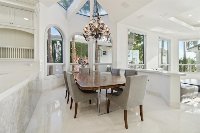 dining space featuring recessed lighting, plenty of natural light, and baseboards