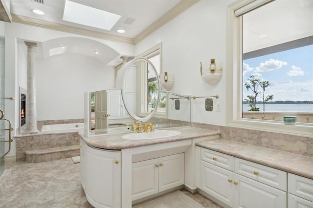 full bath with a wealth of natural light, vanity, a bath, and a premium fireplace