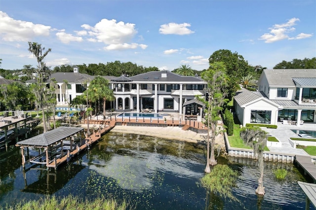 dock area with a water view and a patio