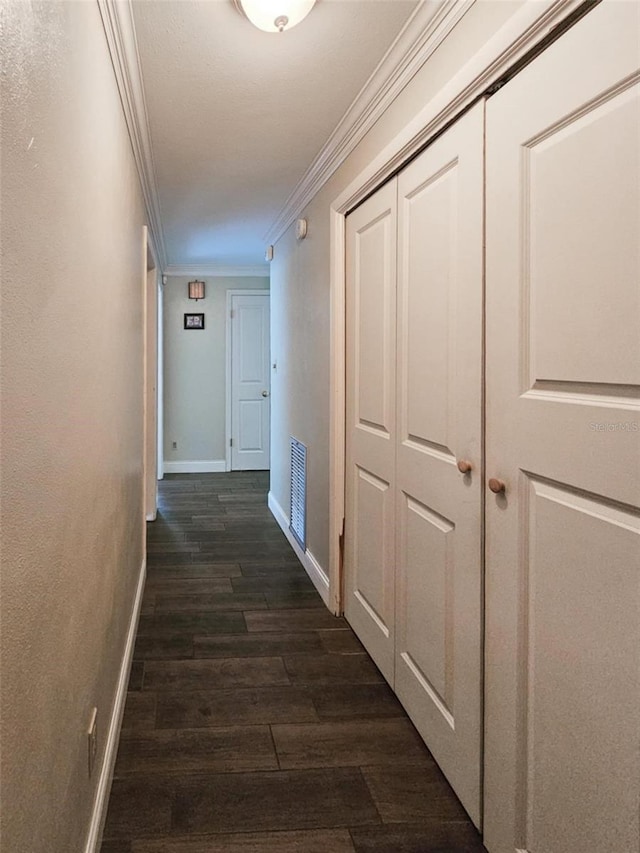 hallway with dark wood-type flooring and crown molding