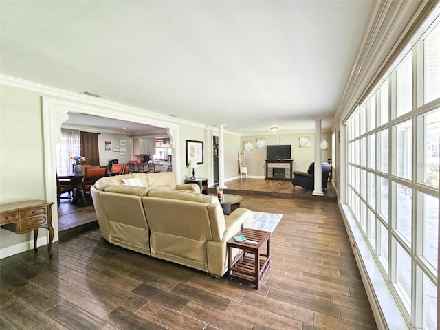 living room with decorative columns and crown molding