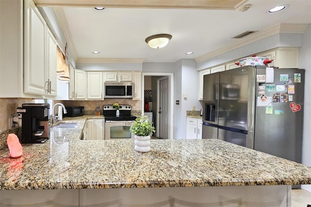 kitchen featuring light stone counters, appliances with stainless steel finishes, ornamental molding, and kitchen peninsula