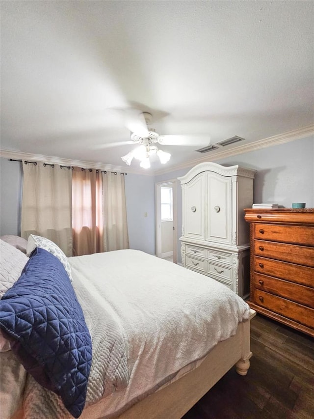 bedroom with ceiling fan, dark hardwood / wood-style flooring, and crown molding