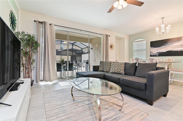 living room featuring ceiling fan with notable chandelier and light tile patterned floors