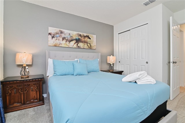 bedroom featuring light carpet and a closet