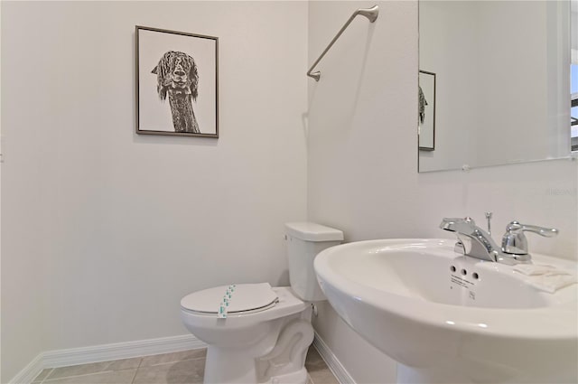 bathroom featuring sink, tile patterned flooring, and toilet