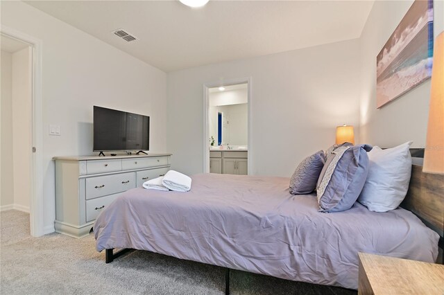 carpeted bedroom with ensuite bathroom