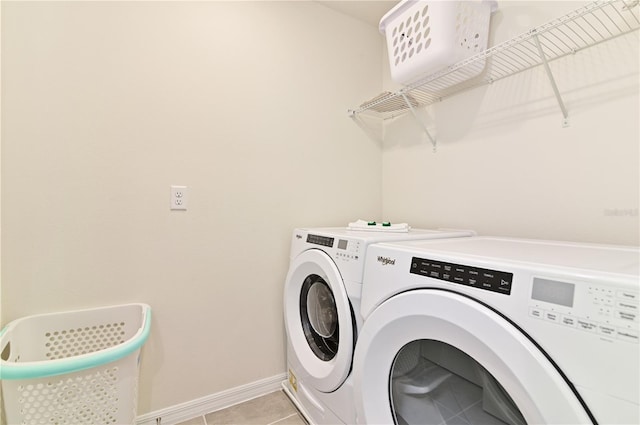 laundry room featuring light tile patterned flooring and washing machine and clothes dryer