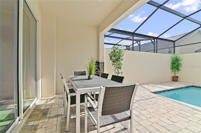 view of pool featuring a patio and glass enclosure