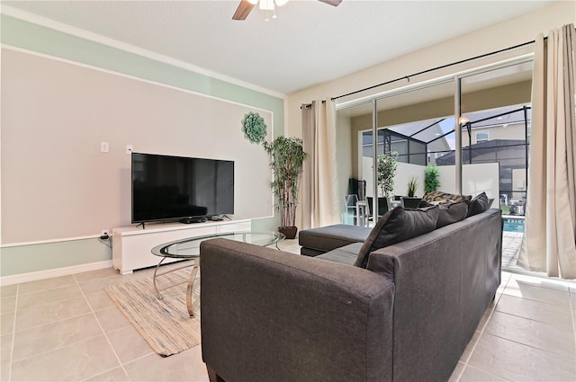 living room featuring light tile patterned flooring, ceiling fan, and a textured ceiling