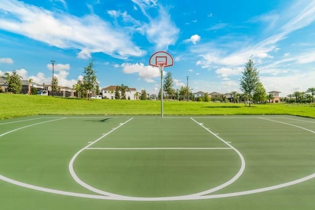 view of sport court featuring a yard