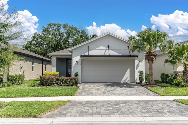 view of front of property with a front yard and a garage