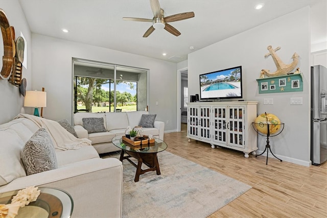 living room featuring light wood-type flooring and ceiling fan