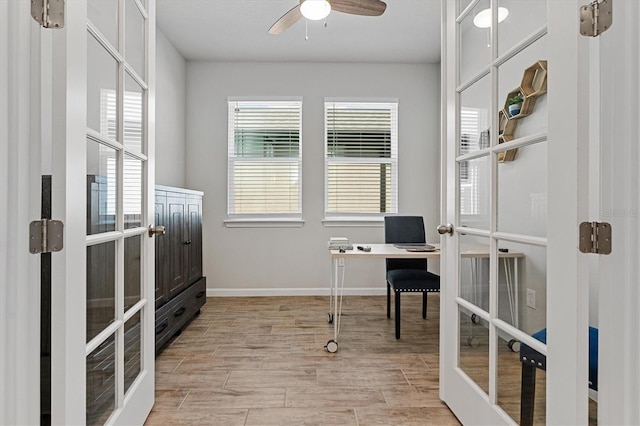 office with ceiling fan and french doors