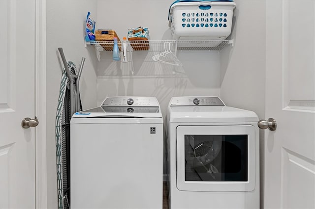 clothes washing area with washer and clothes dryer