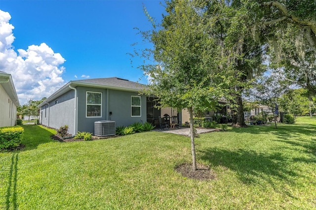 back of property featuring a patio area, a yard, and central air condition unit