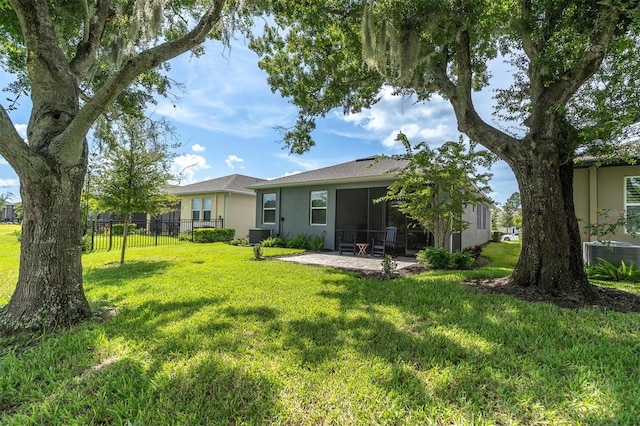 back of property featuring central air condition unit, a lawn, and a patio