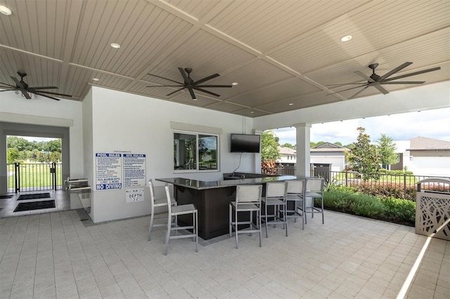 view of patio featuring ceiling fan and an outdoor bar