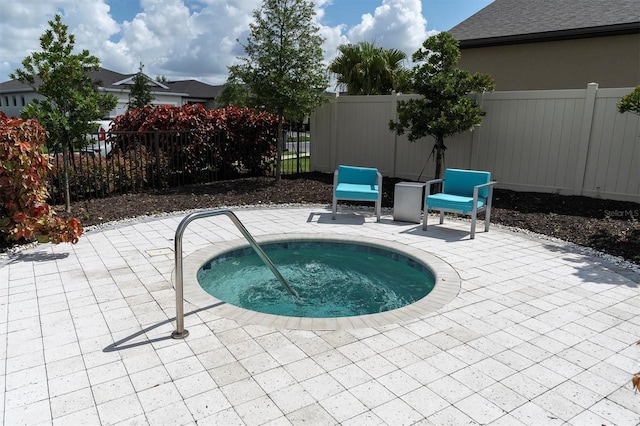 view of swimming pool featuring an in ground hot tub and a patio