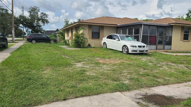 view of side of property with a lawn