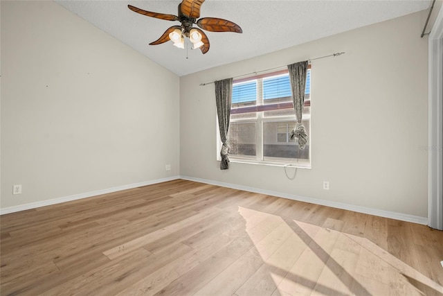 unfurnished room featuring ceiling fan, lofted ceiling, and light hardwood / wood-style flooring