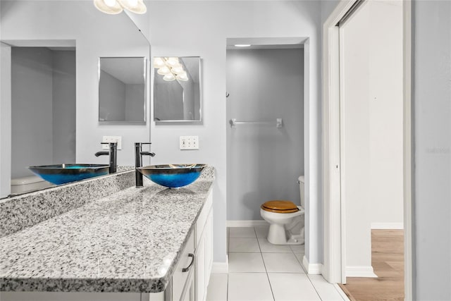 bathroom featuring tile patterned floors, toilet, and vanity