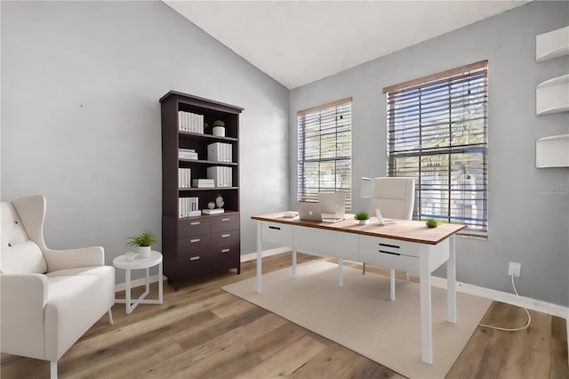 office featuring light wood-type flooring and vaulted ceiling