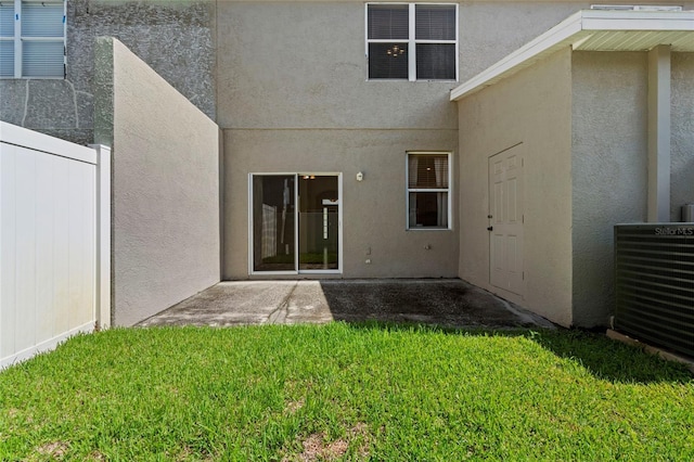 back of house with central AC unit, a patio area, and a yard