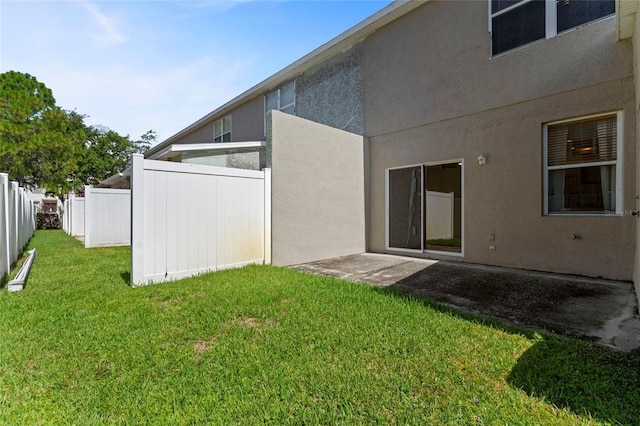 rear view of property featuring a lawn