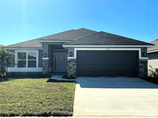 prairie-style house with a front yard and a garage