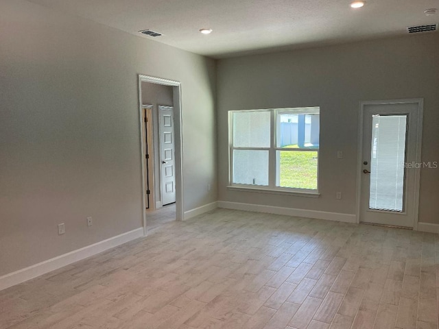 spare room featuring light hardwood / wood-style floors