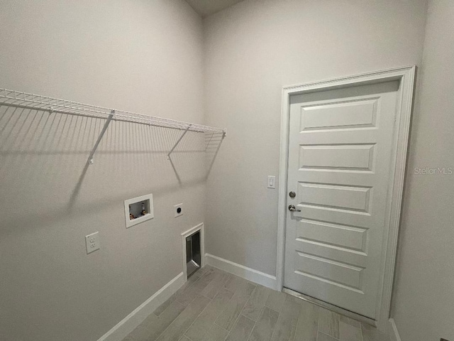 laundry area featuring washer hookup, hardwood / wood-style flooring, and electric dryer hookup