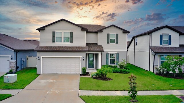 view of front of home with a yard and a garage