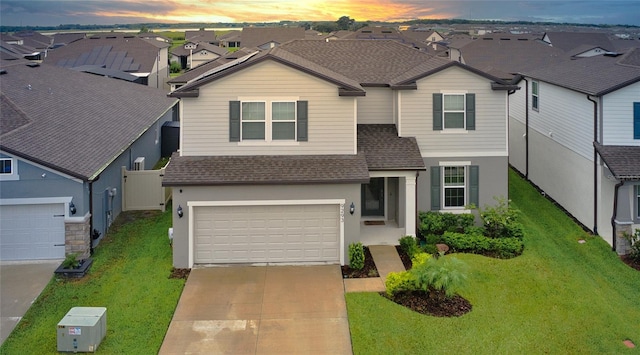 view of front facade featuring a garage and a lawn