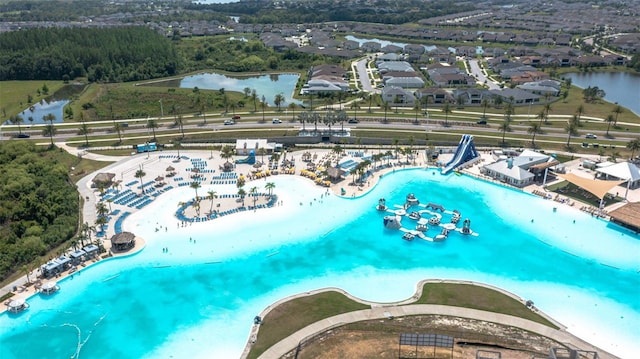 drone / aerial view featuring a water view and a beach view